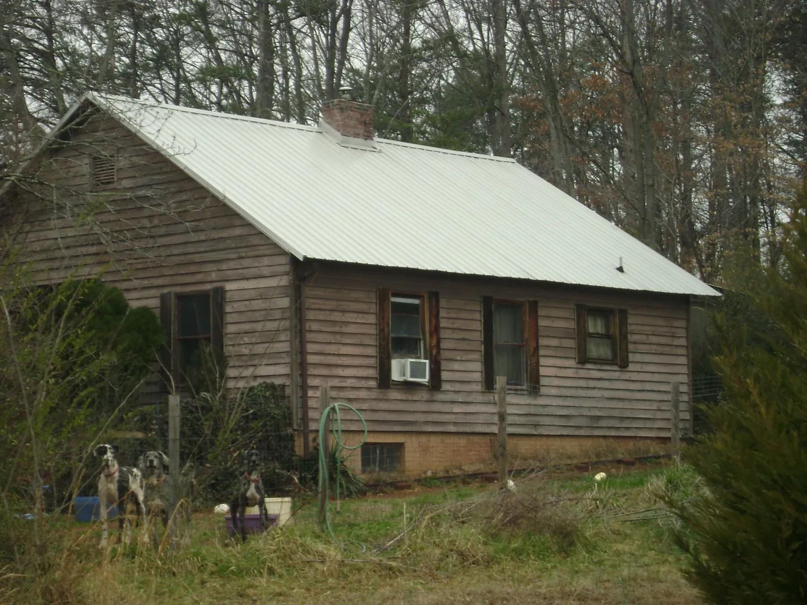 White metal roof on an old wood sided farmhouse, from a Metal Roof Installation job in Westpoint